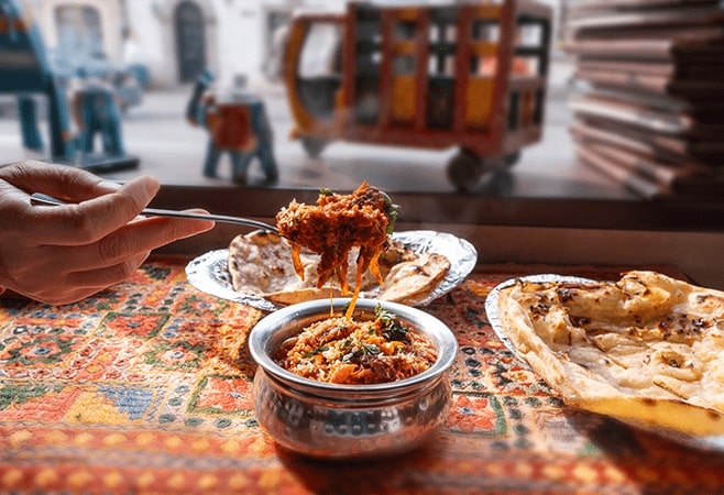 Laal Maas is a fiery red lamb curry with chillies, garlic, and creamy yogurt.