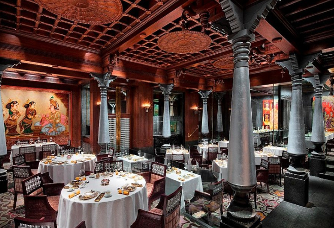 The restaurant boasts ornate decor, including a carved ceiling, and offers traditional cuisine from the four southern states of India