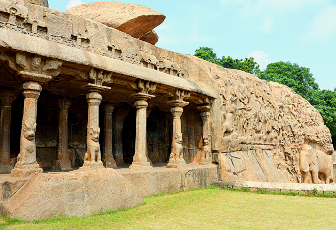 The Varaha Cave Temple is a 7th-century Pallava rock-cut shrine featuring intricate bas-reliefs of Lord Vishnu’s Varaha avatar, showcasing remarkable artistry and spiritual symbolism.